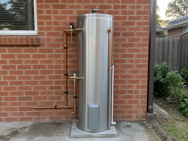 New stainless hot water system on a brick exterior wall beside neat pipework in East Maitland