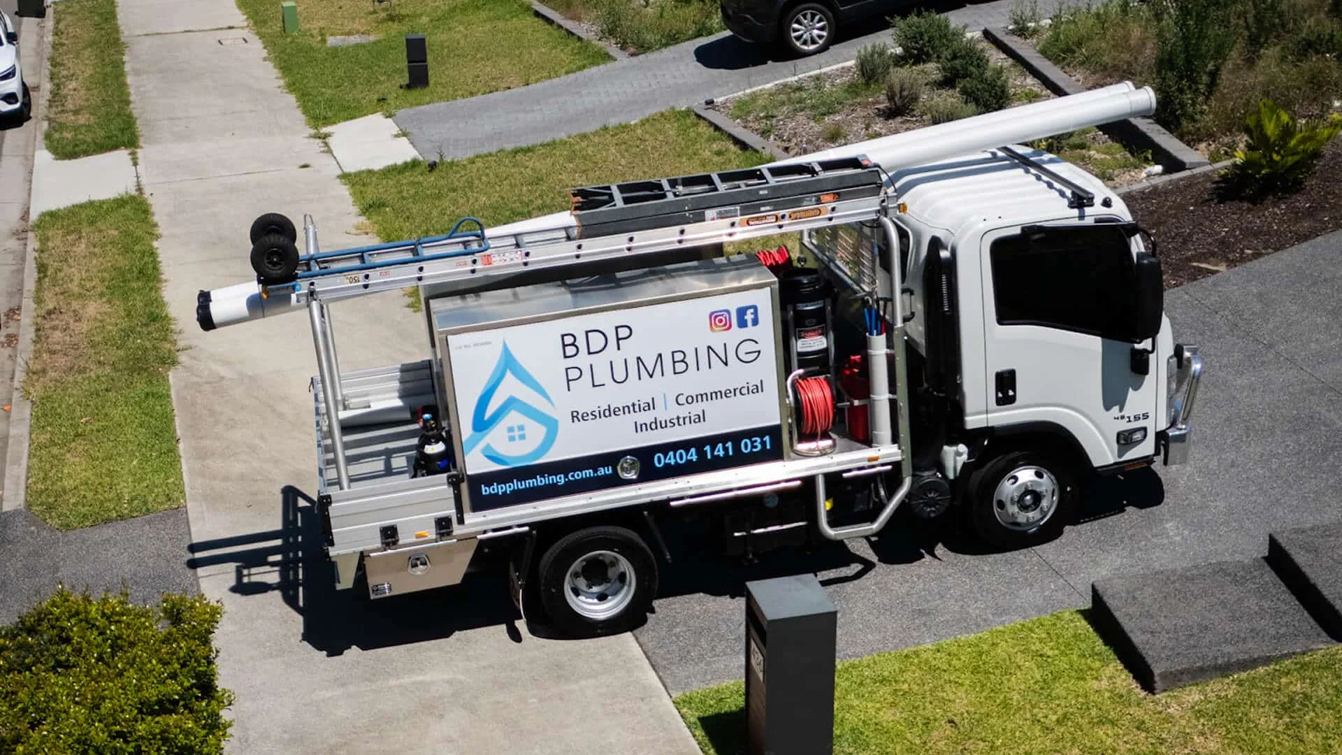 Plumbing service truck parked in a residential street